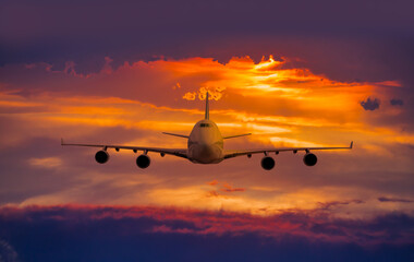 Airplane in the sky at sunset