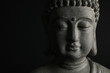 © New Africa - Beautiful stone Buddha sculpture on black background, closeup. Space for text
