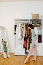 Woman Choosing Clothes In Wardrobe