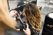 © Javier Pardina/Stocksy - Curling Hair.