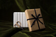 © Anna Tabakova/Stocksy - Holiday wrapped boxes and scissors