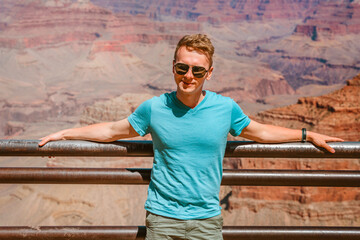 Young man blonde tourist walks in Grand Canyon National Park, Arizona