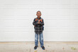 © Jennifer Bogle/Stocksy - Cheerful boy smiles for back to school photo