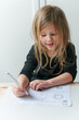 © Lexia Frank/Stocksy - young preschool girl practices writing