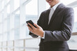 © Attasit - business man using mobile smart phone, copy space.
