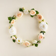Summer wreath made of roses and leaves isolated on a cream background. Round frame layout.