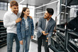 © fotofabrika - Male shop assistant helps young couple to choose new home appliance