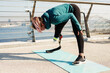 © Drobot Dean - Young sportswoman with prosthesis doing exercise while working out