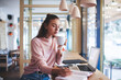 © BullRun - Calm student writing and drinking coffee in coffee shop