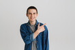 © Drobot Dean - Young brunette man smiling and pointing finger aside