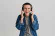 © Drobot Dean - Young brunette man smiling and listening to music with headphones