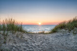 Fototapeta Zachód słońca - Sand dunes on the beach at sunset