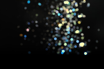 Wall Mural - blurred view of colorful festive lights on black background. bokeh effect