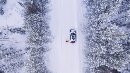 aerial view from drone of car stopping to pick up hitchhikers explore wild destinations on journey, 