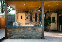 New And Modern Outdoor Kitchen On A Sunny Summer Evening