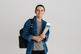 Fototapeta  - Young brunette student man smiling while holding exercise books