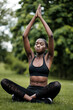 © Jorge Elizaquibel - Young black woman doing meditation and yoga in a park.