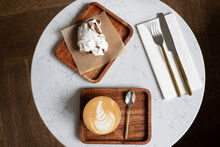Flat White, Meringue And A White Round Table