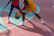 © Atolas/Stocksy - Two young African American men playing basketball.