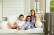 © KCULP - Little Brother and Sisters Sitting on Porch Swing