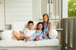 © KCULP - Little Brother and Sisters Sitting on Porch Swing