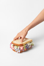 Woman Taking Sandwich With Flowers