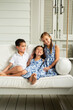 © KCULP - Little Brother and Sisters Sitting on Porch Swing