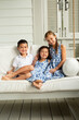© KCULP - Little Brother and Sisters Sitting on Porch Swing