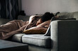 © David Prado/Stocksy - Depressed black woman lying on sofa