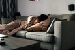 © David Prado/Stocksy - Depressed black woman lying on sofa
