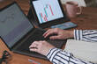 © mckaya - business woman examines stock market charts with laptop