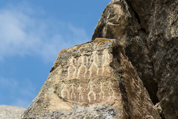 Ancient rock carvings petroglyphs of people in Gobustan National park. Exposition of Petroglyphs in Gobustan near Baku, Azerbaijan.