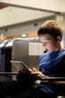 © Maryanne Gobble/Stocksy - Child Looking at Screen in Airport