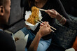 © Sean Locke/Stocksy - Loft: Anonymous Friends Eating Lo Mein And Broccoli