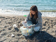 © ZHPH Production/Stocksy - Collecting garbage on the beach