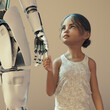 © Don Smith/Stocksy - Futuristic childcare concept, girl holding hand of robot cyborg carer