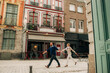 © Olga Moreira/Stocksy - Young couple walking on the street of Lille, France