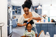 © Kristen Curette & Daemaine Hines/Stocksy - A mother fixing her daughter's hair. Hair care for kids.