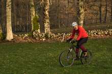 Cyclist Mountain Bike Rides On Grass