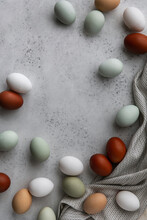 Multicolored Eggs And Cloth On Concrete Table