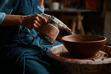 Image Of Process Modeling Ceramic Bowl With Special Instrument In Pottery Workshop