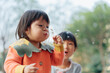 © Pansfun Images/Stocksy - two little girl blowing dandelion