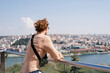 © Alina Hvostikova/Stocksy - Man admiring river in city