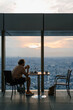 © Alina Hvostikova/Stocksy - Unrecognizable man resting near window in cafe in evening