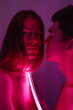 © Alina Hvostikova/Stocksy - Sensual boyfriends with neon lamp