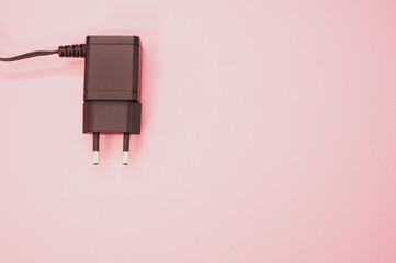 Sticker - Top view of wired charger adapter isolated on pink background