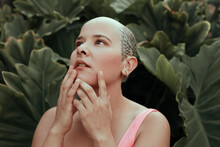 Emotional Portrait Of A Beautiful Bald Woman With Tattoo On Her Head, Posing In A Garden