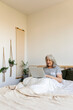 © Valentina Barreto/Stocksy - relax mature woman with laptop on bed