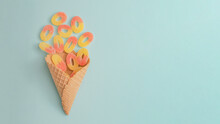 Creative Summer Food Idea With Colorful Gummy Candies In An Ice Cream Cone. Bright Blue Background, Copy Space Vertical Arrangement. Tasty Sweets Concept.