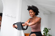 © Studio Firma/Stocksy - Woman Riding a Stationary Bike
